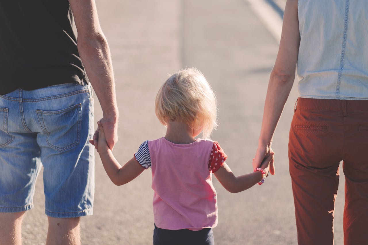 why-choose-us A family enjoying a sunny walk outdoors, hand-in-hand, symbolizing togetherness and love.