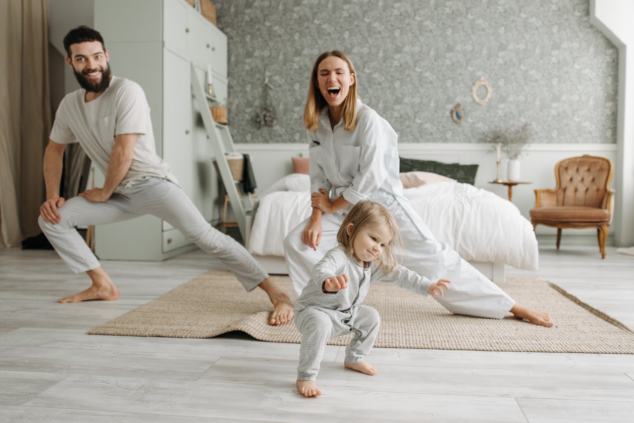 services-03 A joyful family engaging in morning stretches together, fostering a fun and healthy routine.